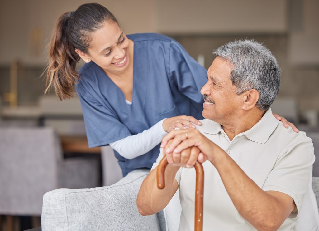 Healthcare, kindness and support with nurse helping elderly patient in assisted living home, smile